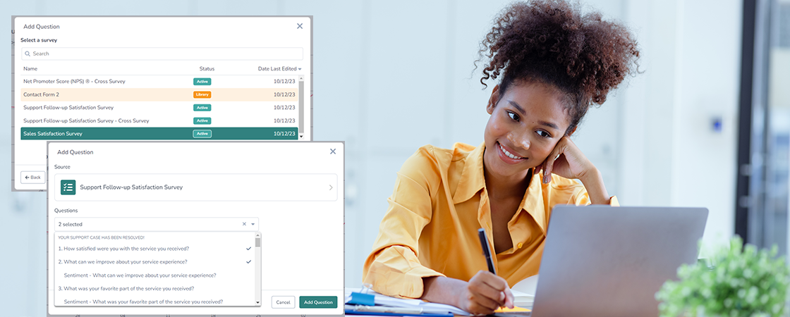 A woman with curly hair, wearing a yellow sweater, is sitting at a desk. She is smiling and writing in a notebook while looking at a laptop. Behind her, survey creation software windows are open on the screen.